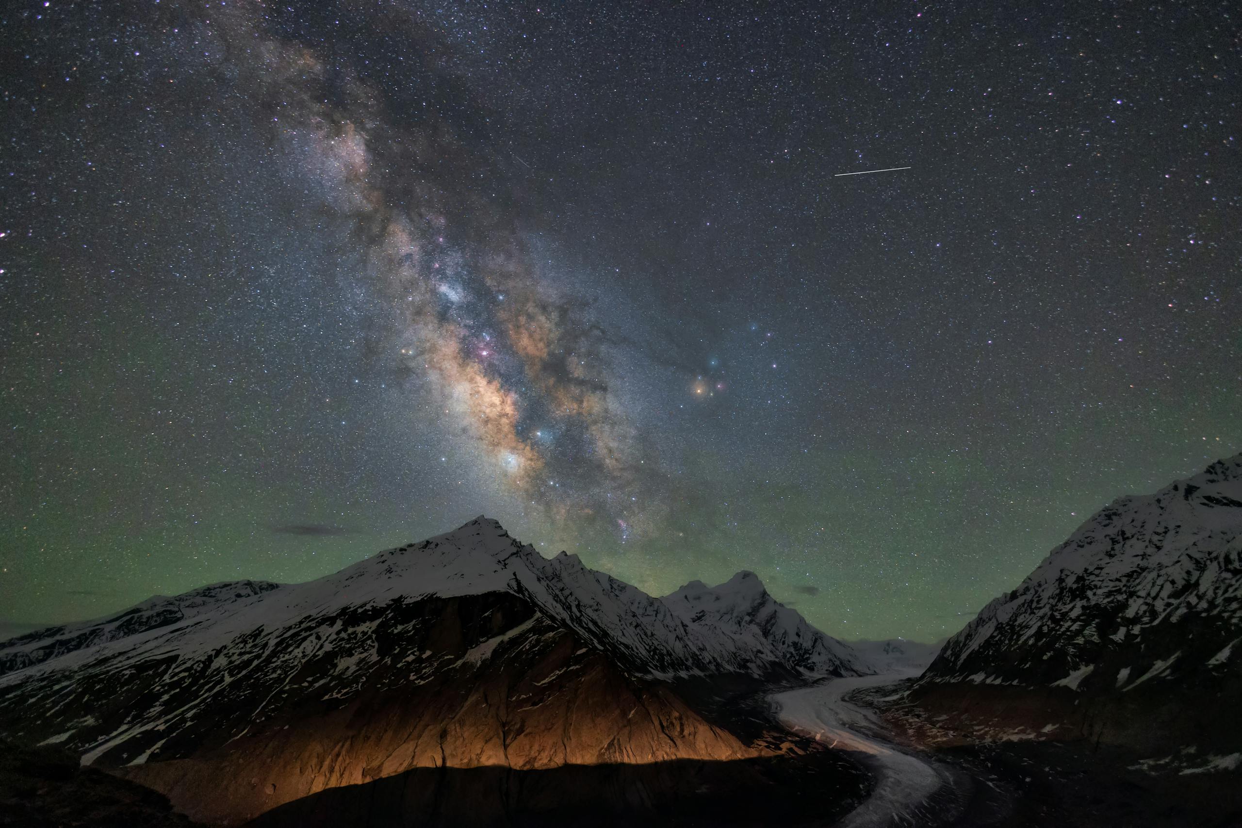 A breathtaking view of the Milky Way over snowy peaks in Zanskar, India. Perfect for stargazing enthusiasts.
