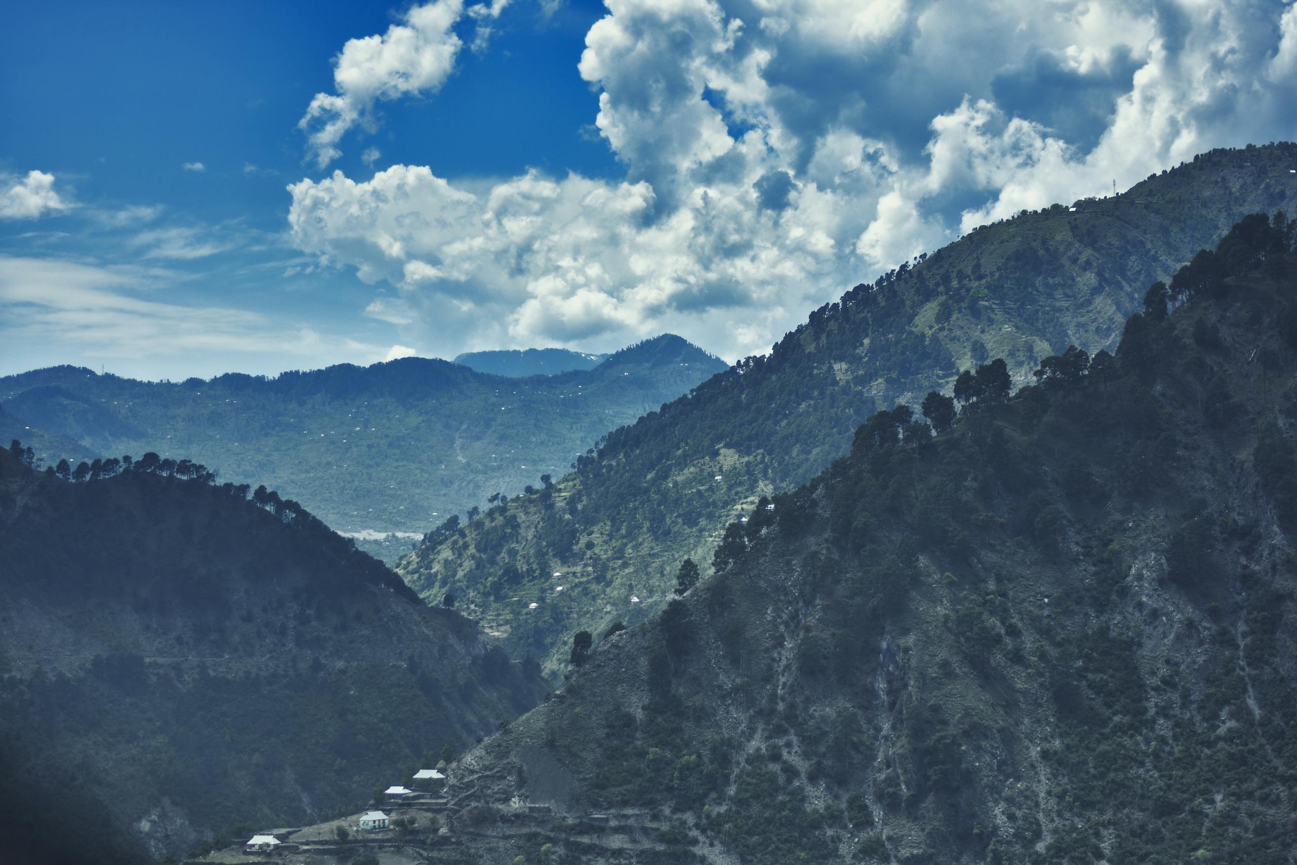 Picturesque view of the mountains in Katra under a clear blue sky with clouds.