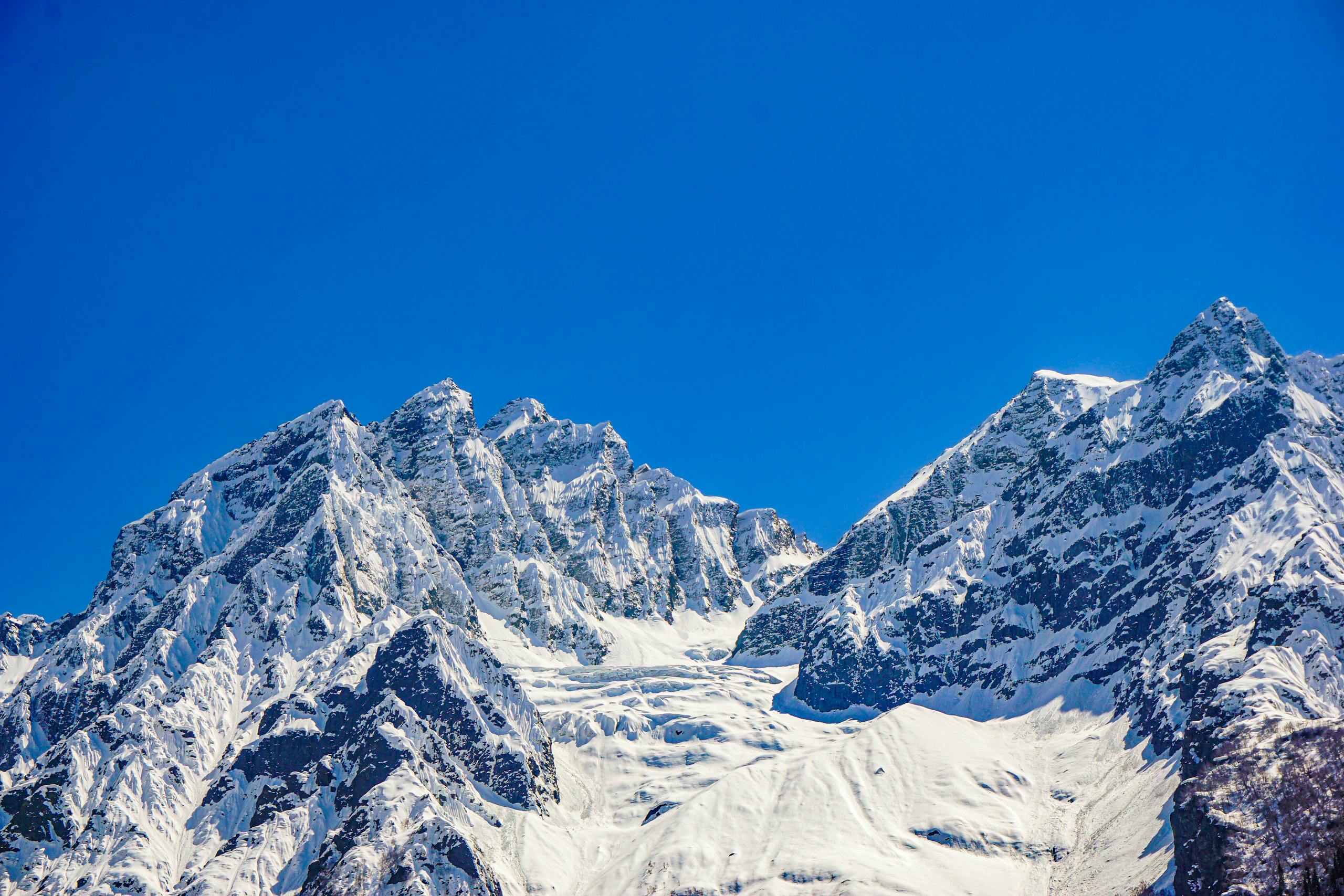 Stunning view of the snow-covered mountains in Sonamarg under a clear blue sky.