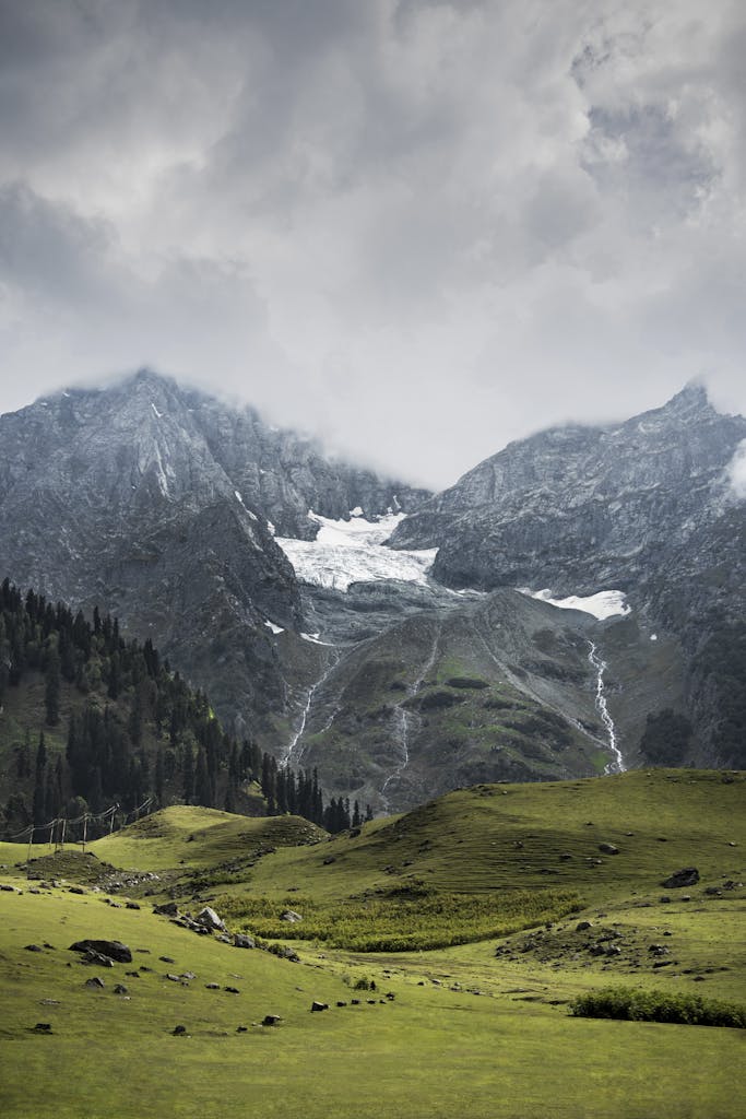 Stunning winter mountain landscape featuring snow and serene meadows in Jammu and Kashmir.